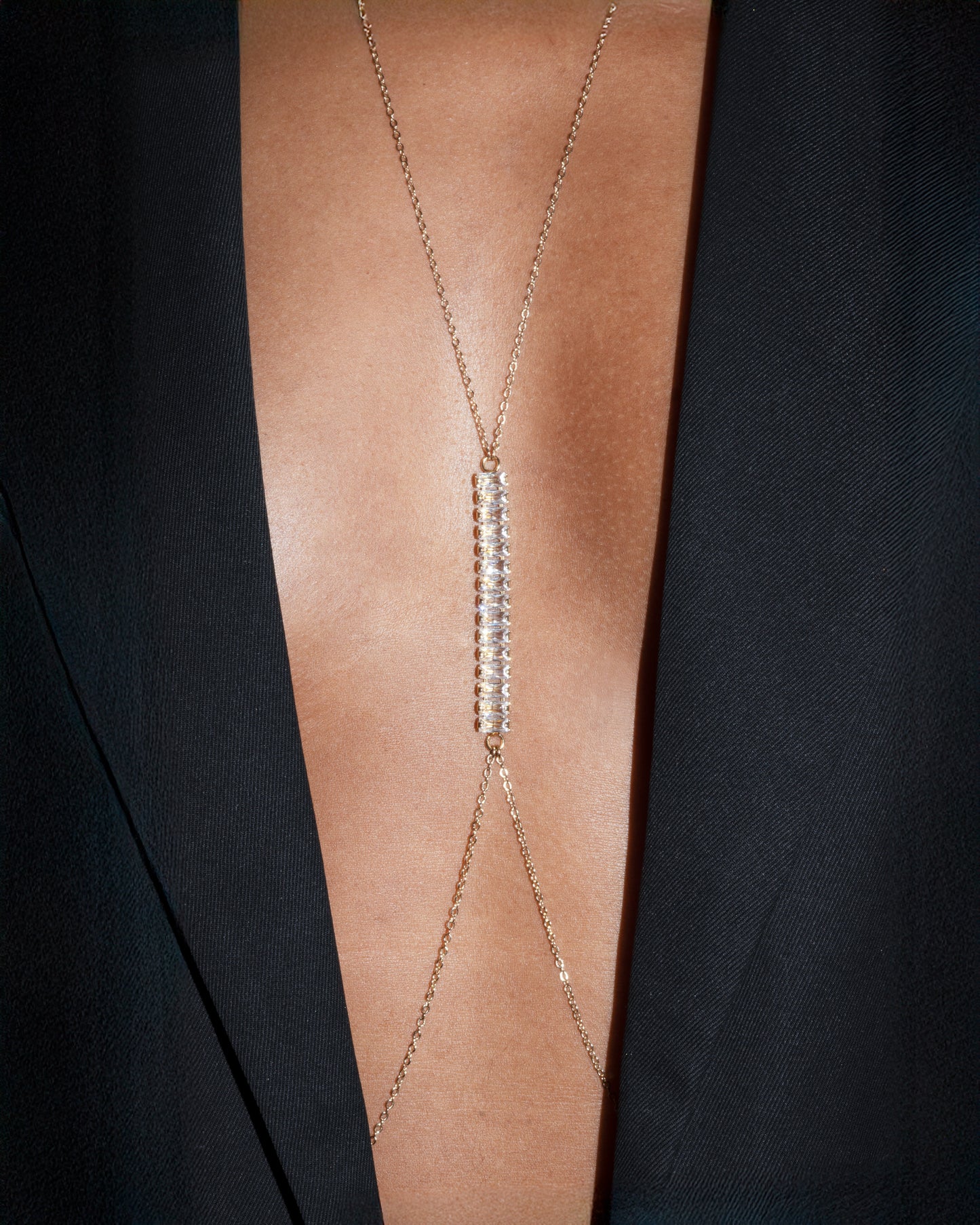 Close Up Axis necklace by Studio Baloge — gold-filled chain with vertical pavé crystal bar worn with deep V neckline.