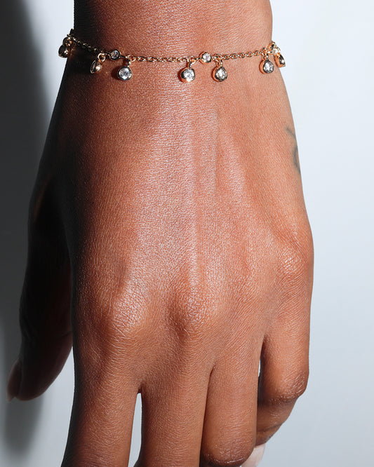 Diamond Drift Bracelet worn on wrist, delicate gold-filled chain with diamond-like crystal clusters catching the light.