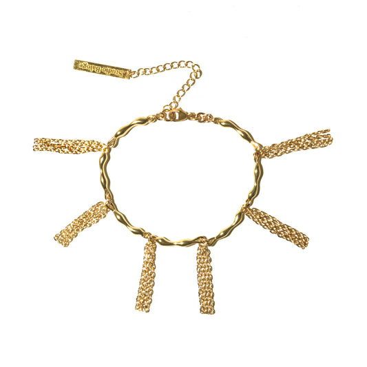 Gold bracelet with chain tassels on a white background