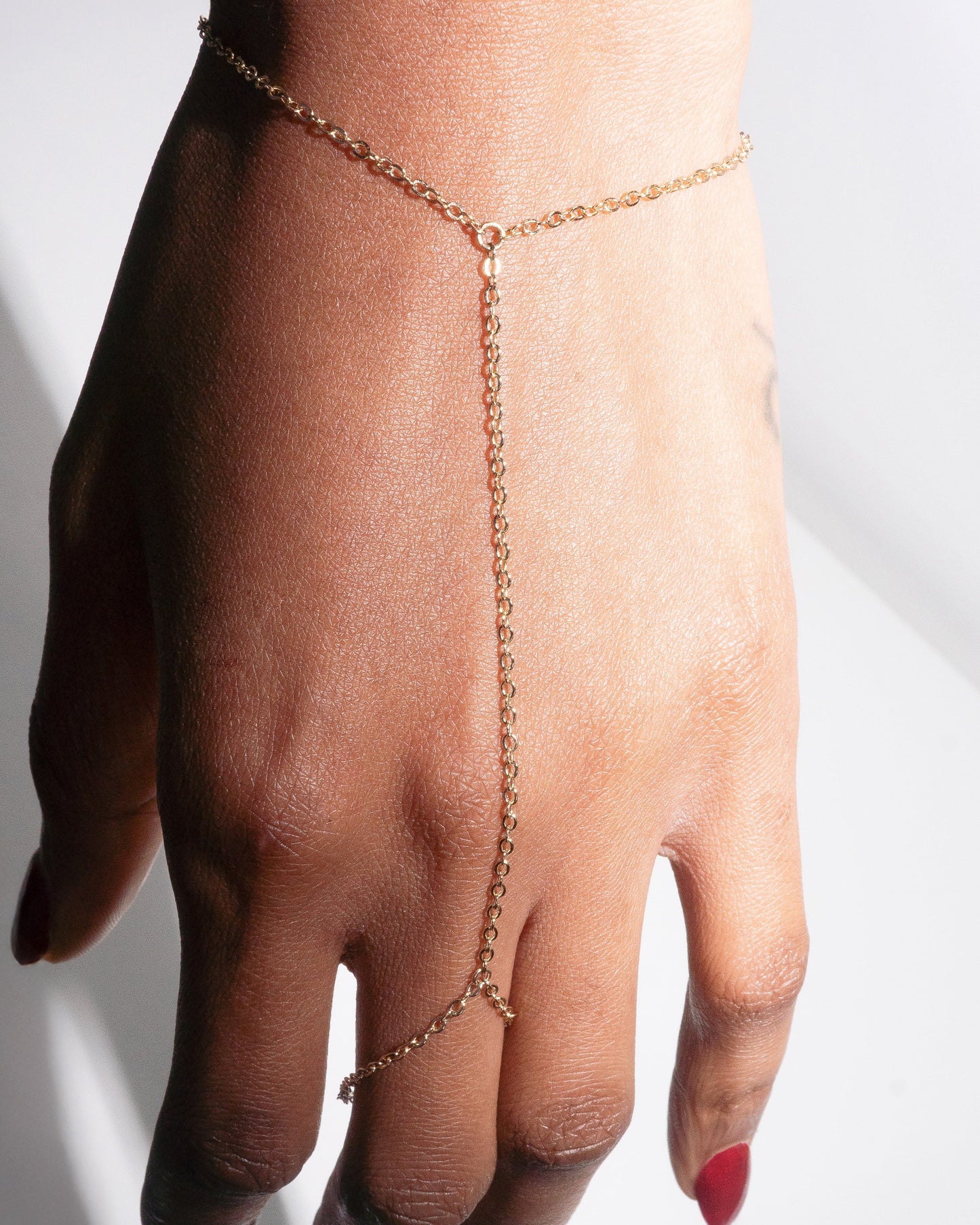 Kyma Hand Harness – gold dainty hand chain from Studio Baloge's Bare Trace collection, photographed on skin for a soft, minimalist aesthetic.