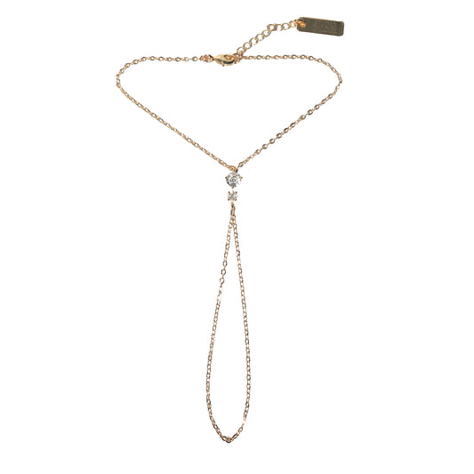 Gold hand harness with diamond charm on a white background