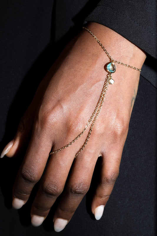 Point Hand Harness worn on hand featuring a single aquamarine gemstone drop
