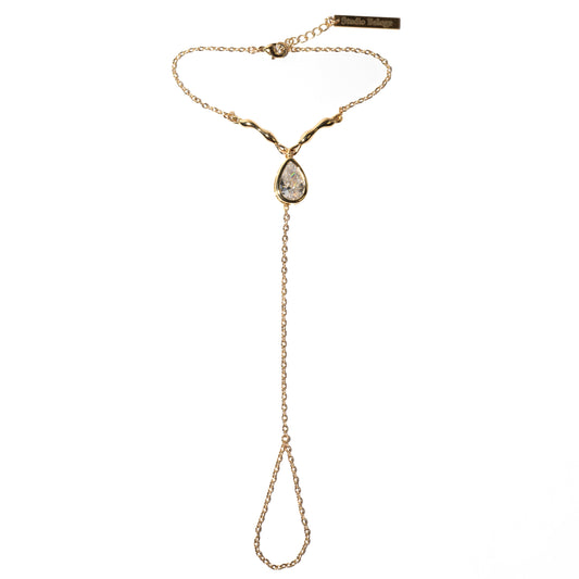 Gold hand harness with a teardrop-shaped pendant on a white background