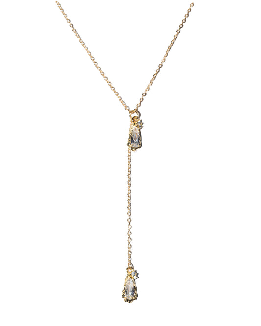 Gold necklace with a teardrop-shaped pendant on a white background