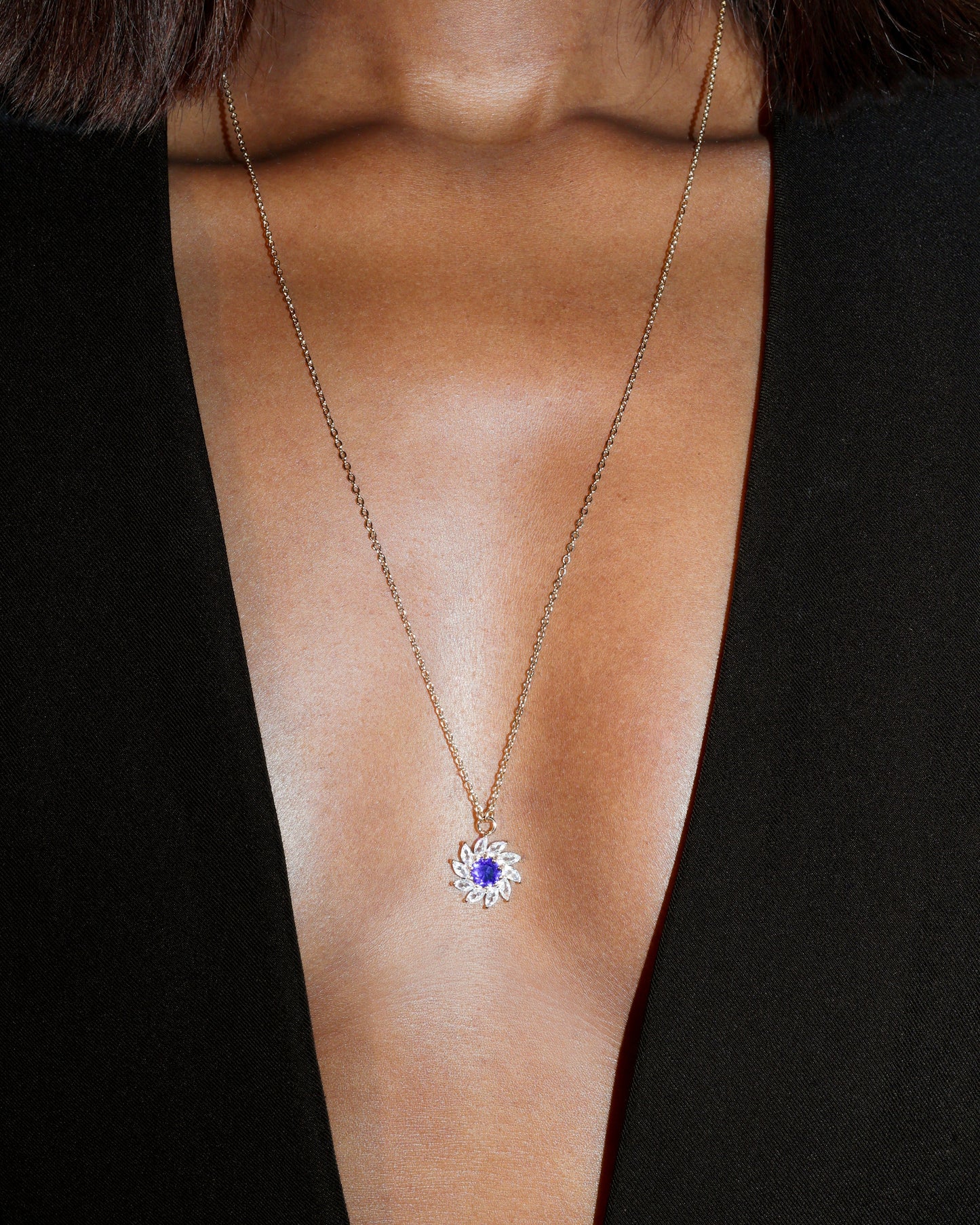 Necklace with a blue gemstone pendant on a black background