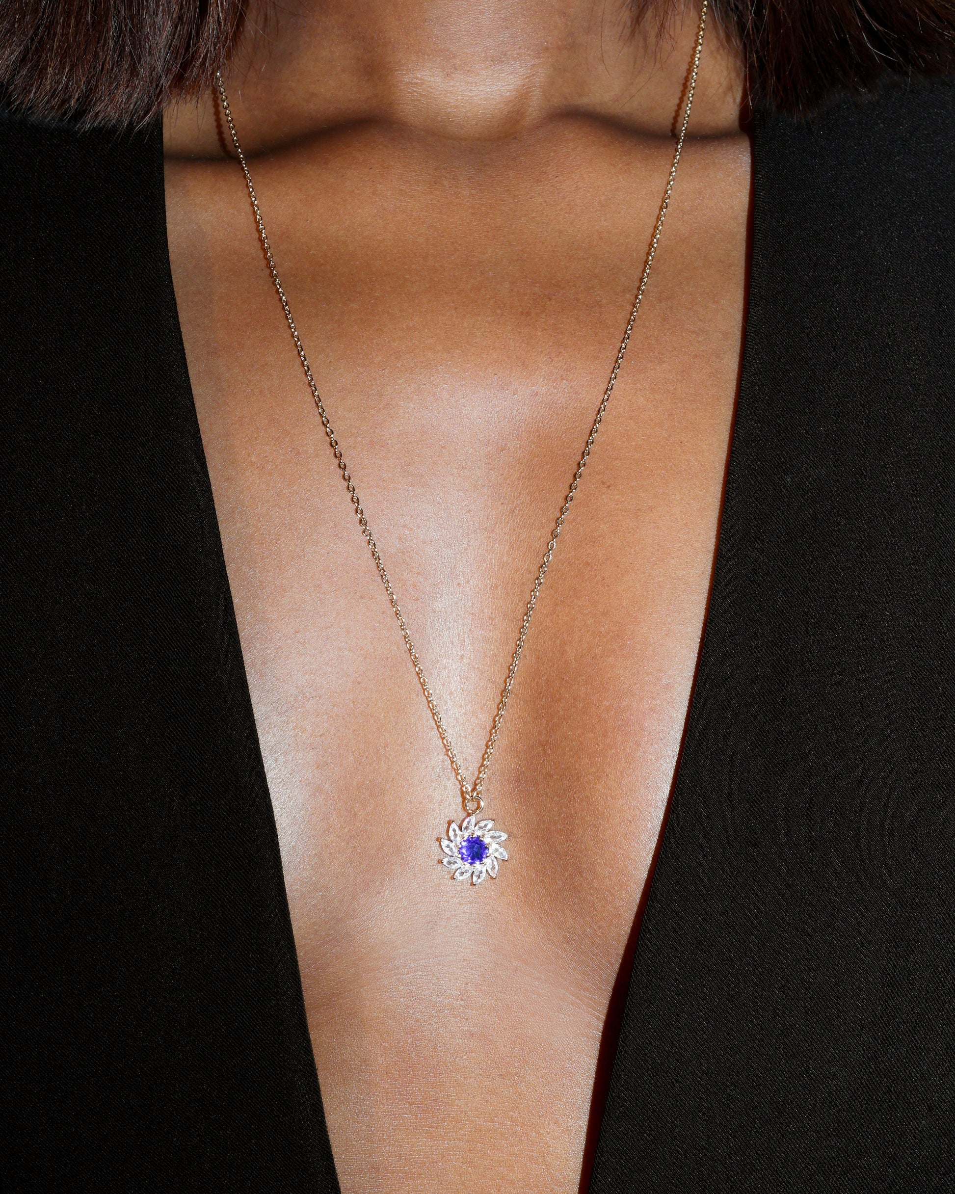 Necklace with a blue gemstone pendant on a black background