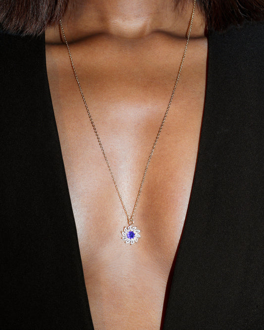 Necklace with a blue gemstone pendant on a black background