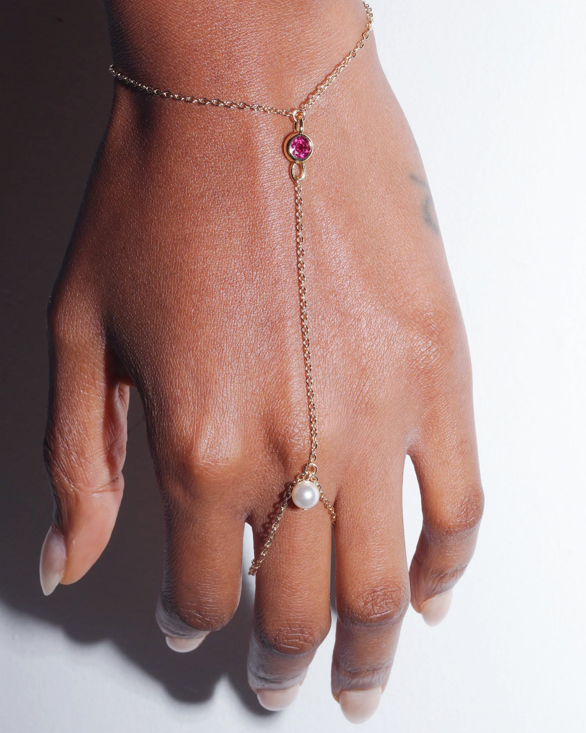 Petale Hand Harness worn on hand with pink crystal and pearl detail