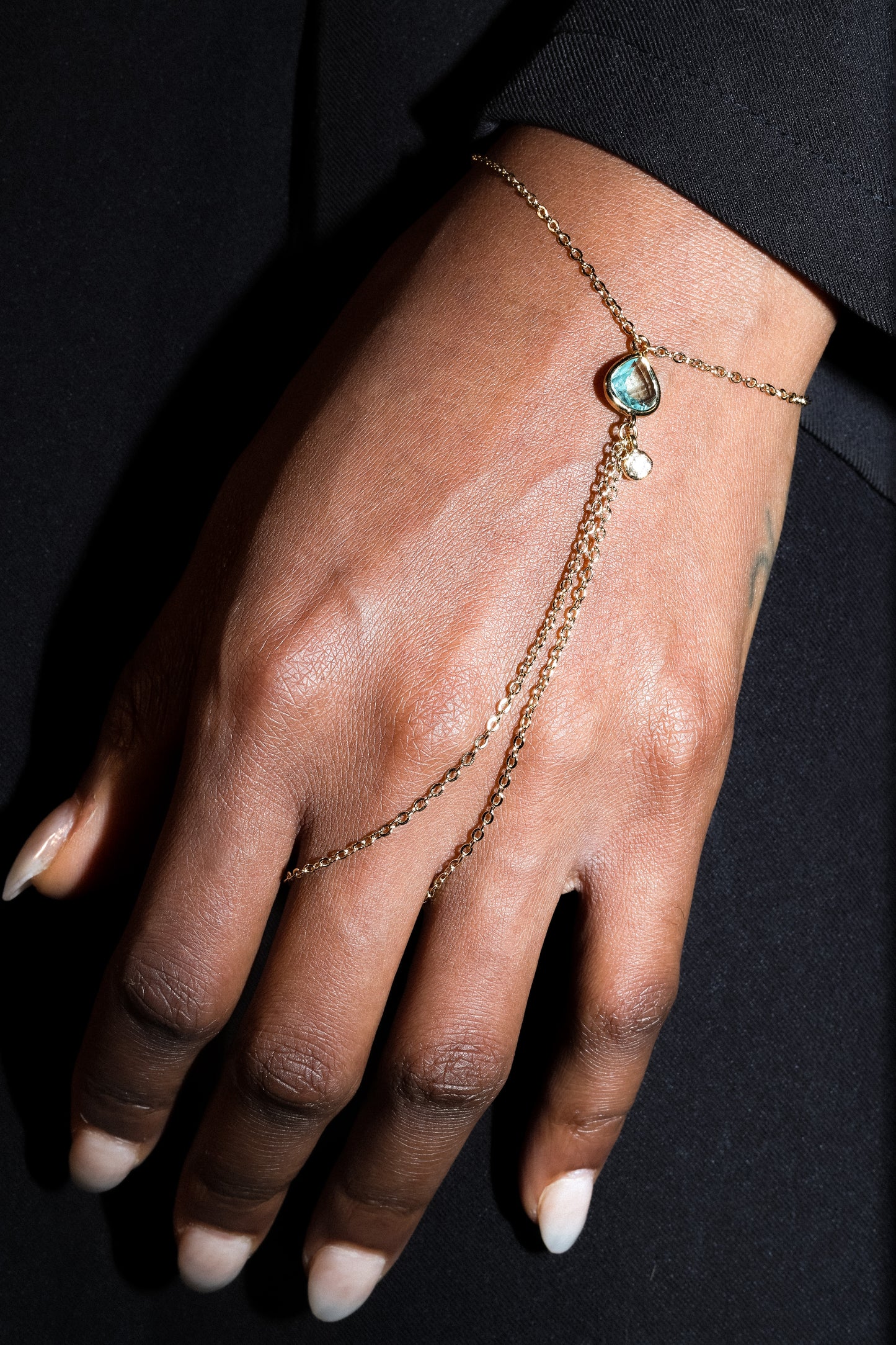 Point Hand Harness worn on hand featuring a single aquamarine gemstone drop