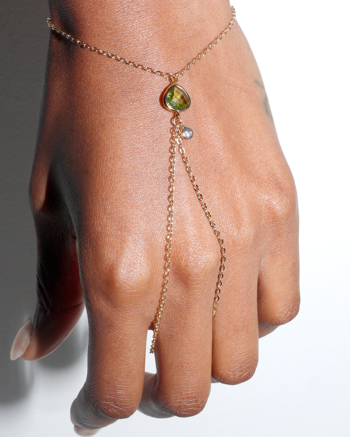 Point Hand Harness worn on hand featuring a single peridot gemstone drop