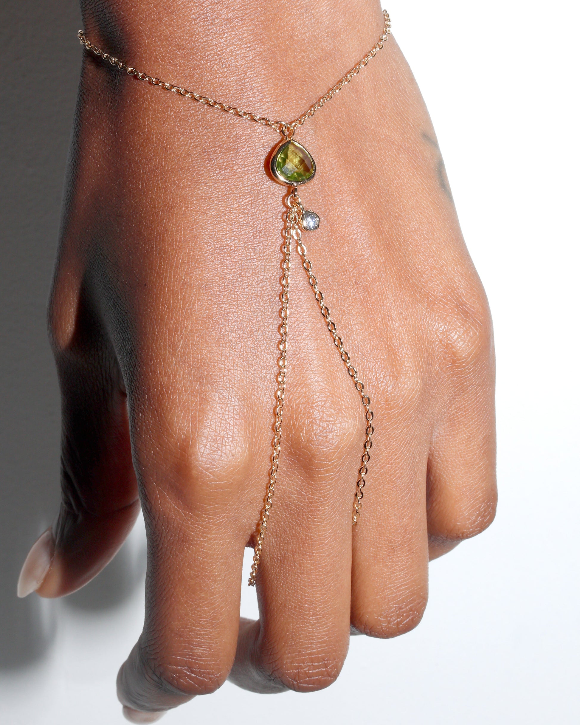 Point Hand Harness worn on hand featuring a single peridot gemstone drop