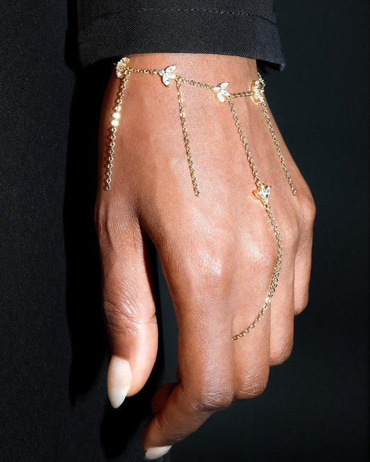 Gold hand chain on a dark background