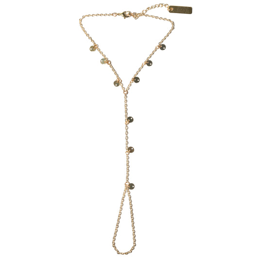 Gold hand harness with gold discs on a white background